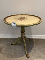Full view of the antique style tilt top parlour table showing the round scalloped edge top with center floral painting and pedestal base with claw feet.