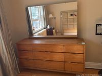 Front angle view of dresser with mirror above