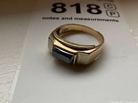 Ring angled view showing hematite stone set in gold band