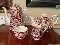 All four pieces displayed together: coffee pot, teapot, cream pitcher, sugar bowl