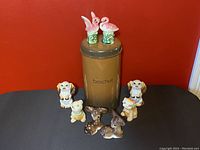 Photo of grouping the Belgium biscuit tin with animal-shaped salt and pepper shakers.