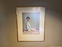Frontal view of the framed fine art print showing the portrait of a seated woman in profile with detailed traditional attire under glare-free glass.