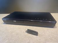 Front view of Samsung BD-P3600 BluRay Player with USB Key placed in front.