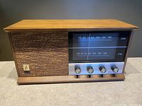 Front view of Shonola by Electrohome tube AM/FM radio showing wooden cabinet and analog dial with four control knobs.