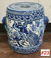 Front view showing peacock and crane scene with floral border and one lion head handle