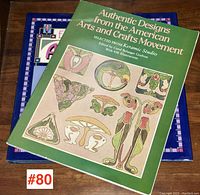 Two art reference books stacked on a wooden surface, showing partial covers and condition.