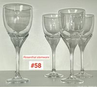 Four Rosenthal stemware wine glasses in the Iris pattern shown grouped together; one glass tallest at 8.25 inches, others 7.75 inches tall.