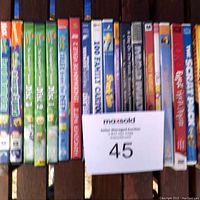 Front view of 19 assorted kids DVDs lined up, showing titles and cover art including Nickelodeon SpongeBob SquarePants multiples and other kids movies.