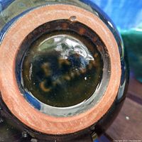 Bottom mark of Blue Mountain Pottery brand on ceramic piece, showing glaze and signature under the base