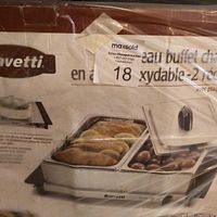 Photo of the original box showing the Bravetti buffet server with food inside the two chafing dishes, showcasing the product and branding.