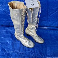 Front view of retro silver gogo boots showing full height, lacing and side zipper.