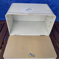 Open metal bread box showing inside and hinged lid with small handle