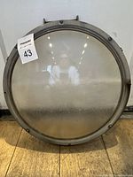 Front view of the round port window with metal frame and glass