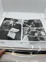 Two black and white movie stills from "BIG" featuring Tom Hanks and a woman reviewing documents.