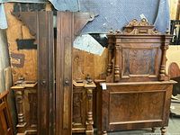 Wide view of the pair of antique Eastlake style bed frames with headboards and footboards shown from the front and stacked view.