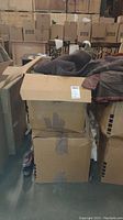 Two taped cardboard boxes with men's clothing and hunting gear inside