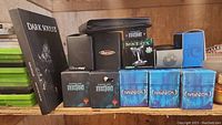 Shelf display of MTG boxes, deck boxes, card tins, and Dark Souls III guide