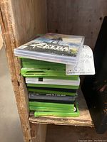 Stack of Xbox game cases with one Nintendo Switch game on top