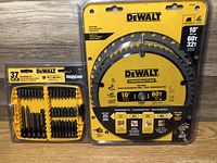 Two unopened 10-inch DeWalt saw blades with 60 teeth each plus a 37-piece DeWalt screwdriving bit set in ToughCase.