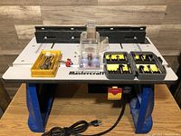 Mastercraft router table overall view with bits arranged on top and power cord visible