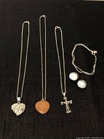 Full set showing all 3 necklaces with different pendants, the bracelet, and the pair of earrings.