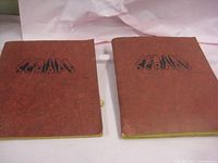 Two antique scrapbooks from the 1940s with brown covers labeled 'Scraps'