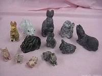 All 11 collectible bunny figures made from various materials on pink backdrop.