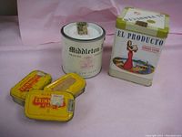 Five vintage tobacco tins on a pink background: three yellow Murray's Erinmore Flake tins, one white Middleton's round tin, and one tall El Producto tin with colored image