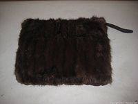 Photo of dark brown mink fur muff showing the fur side.