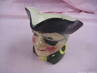 Front view of hand painted pirate Toby mug showing detailed face with black tricorn hat and eye patch.