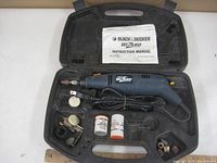 Black & Decker Wizard rotary tool inside black molded plastic carrying case with cord, instruction manual, and various accessories shown in compartments.