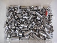 Multiple chrome sockets in a white container showing various sizes and shapes.