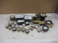 Wide view of lot consisting of approximately 16 various analog gauges and flowmeters in different sizes and styles.
