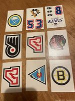 Front side of 7 Ontario Printed Circuits hockey cards featuring team logos: Buffalo Sabres, Pittsburgh Penguins (53), Los Angeles Kings, Philadelphia Flyers, Chicago Blackhawks, Colorado Rockies, Boston Bruins.