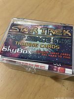 Top view of the card set inside a clear plastic case shows the front card with branding 'Star Trek Deep Space Nine Trading Cards SkyBox' and promotional tagline.