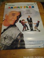 Full view of the rolled video movie poster showing Leslie Nielsen and Judge Reinhold with colorful title FAMILY PLAN and promotional text.