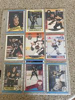 Photo showing 9 different Mario Lemieux Pittsburgh Penguins hockey cards in a sheet protector, variety of manufacturers and designs.