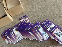 Photo of loose 1991-92 SCORE American edition hockey cards with purple backs, fanned out showing player images and text.