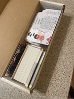 View inside box showing stacked hockey cards with player information visible on some cards