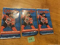 Three unopened 2020-21 O-Pee-Chee hockey cards sealed packs featuring an Edmonton Oilers player on front of each pack.