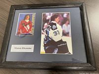 Framed sports collectible featuring signed Manon Rheaume hockey card and a color photo of her in goalie gear.