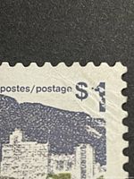 Close-up of the $1 value and 'short $' printing error on top right corner of stamp.