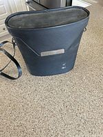 Black hard-sided carrying case labeled Playmaker with shoulder strap