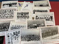 Set of 12 vintage black and white hockey team photos and accompanying printed sheets, laid out on a red surface