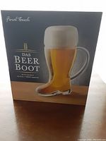 Das Beer Boot glass beer boot drinking cup in box, showing clear boot-shaped glass with handle and brand logo.