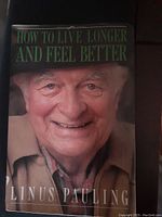 Front cover of 'How to Live Longer and Feel Better' showing a close-up of an elderly man smiling, author Linus Pauling's name at the bottom.