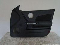 Black passenger side door panel for Pontiac Grand Prix, includes integrated speaker area and handle cutout.