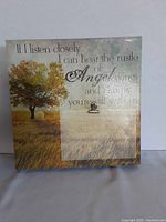Front view of wooden hanging clipboard frame with tree image and inspirational quote.