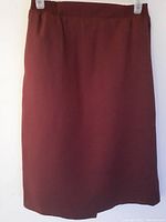 Front view of dark reddish-brown women's skirt with smooth waistband and straight cut