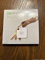 Front of box showing two Tile Mate trackers on a keychain and with the text 'Find your keys, phone, anything'.